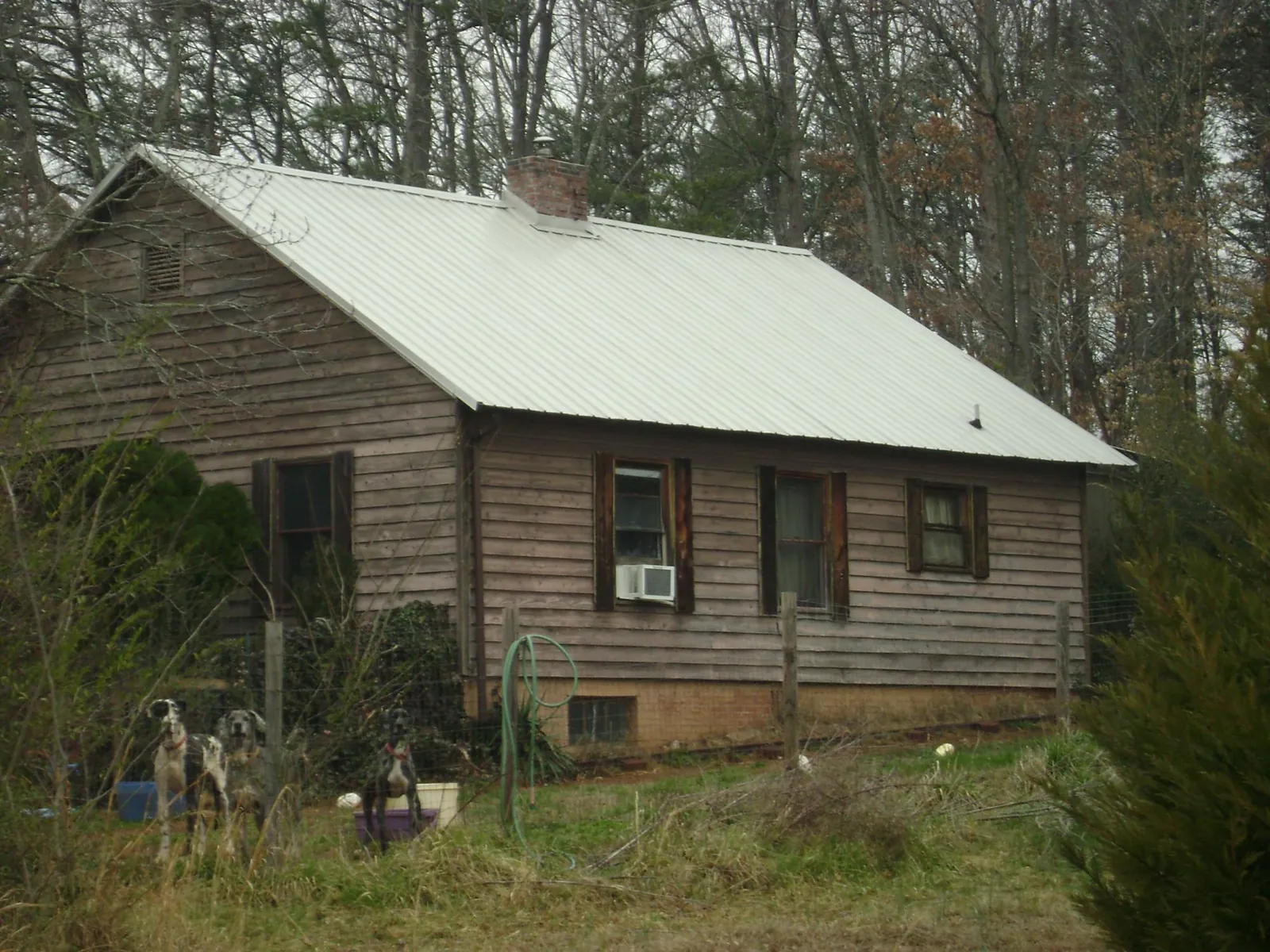 White metal roof on an old wood sided farmhouse, from a Asphalt Shingle Roof Repair job in Wakita